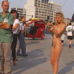 At an open square giving away balloons