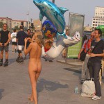 At an open square giving away balloons