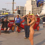 At an open square giving away balloons