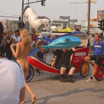 At an open square giving away balloons