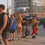 At an open square giving away balloons