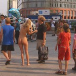 At an open square giving away balloons