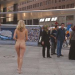 At an open square giving away balloons