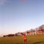 On a green area next to the river bank