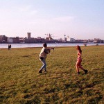 On a green area next to the river bank