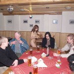 At a holiday home and in a bar with some friends