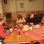 At a holiday home and in a bar with some friends