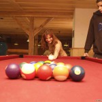 At a holiday home and in a bar with some friends