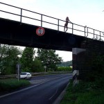 On a railway bridge above a street